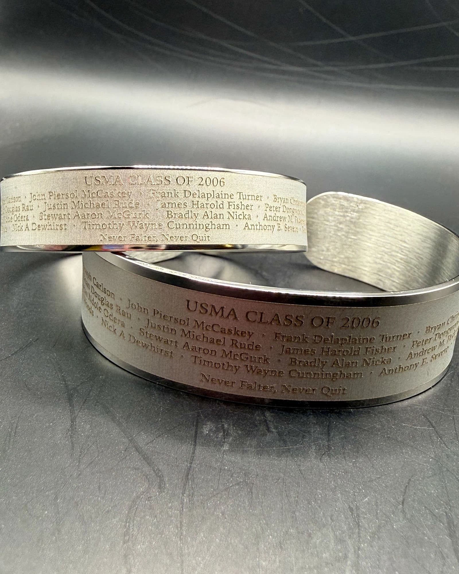 Two finished USMA Class of 2006 memorial bracelets showing the approved 18-name roster engraving.